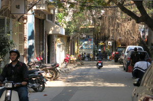 A quiet sidestreet, one of many with large trees shading them.