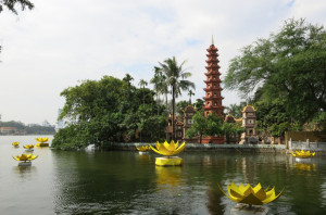 Tran Quoc Pagoda and floating lotus flowers on West Lake.