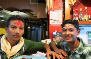 Locals at our favorite restaurant observing the Hindu festival traditions with the forehead mark or "tikka," this one made up of colored powder and rice. 