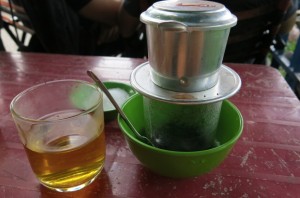 Cambodian filter coffee, served with a glass of jasmine tea, used to dilute the diesel-fuel like consistency of the local coffee.