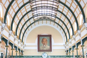 The inside of the Post Office showcases a long, domed roof and tiled floors, with a portrait of Ho Chi Minh at the center of attention. 