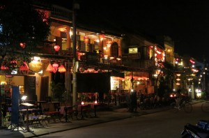 The waterfront on the opposite side of the bridge was filled with restaurants and bars, lit with lanterns.