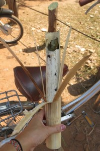 A snack of sticky rice flavored with coconut and mung bean before stuffed in bamboo. Just peel and eat!