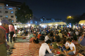The market crowd spread across the mats to devour the food on offer.