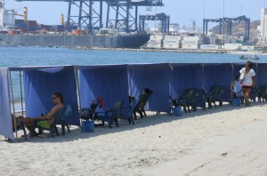 Beach lounging with a calming view of the...shipping yards. 