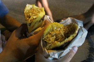 Chicken street arepas  topped with potato crisps.